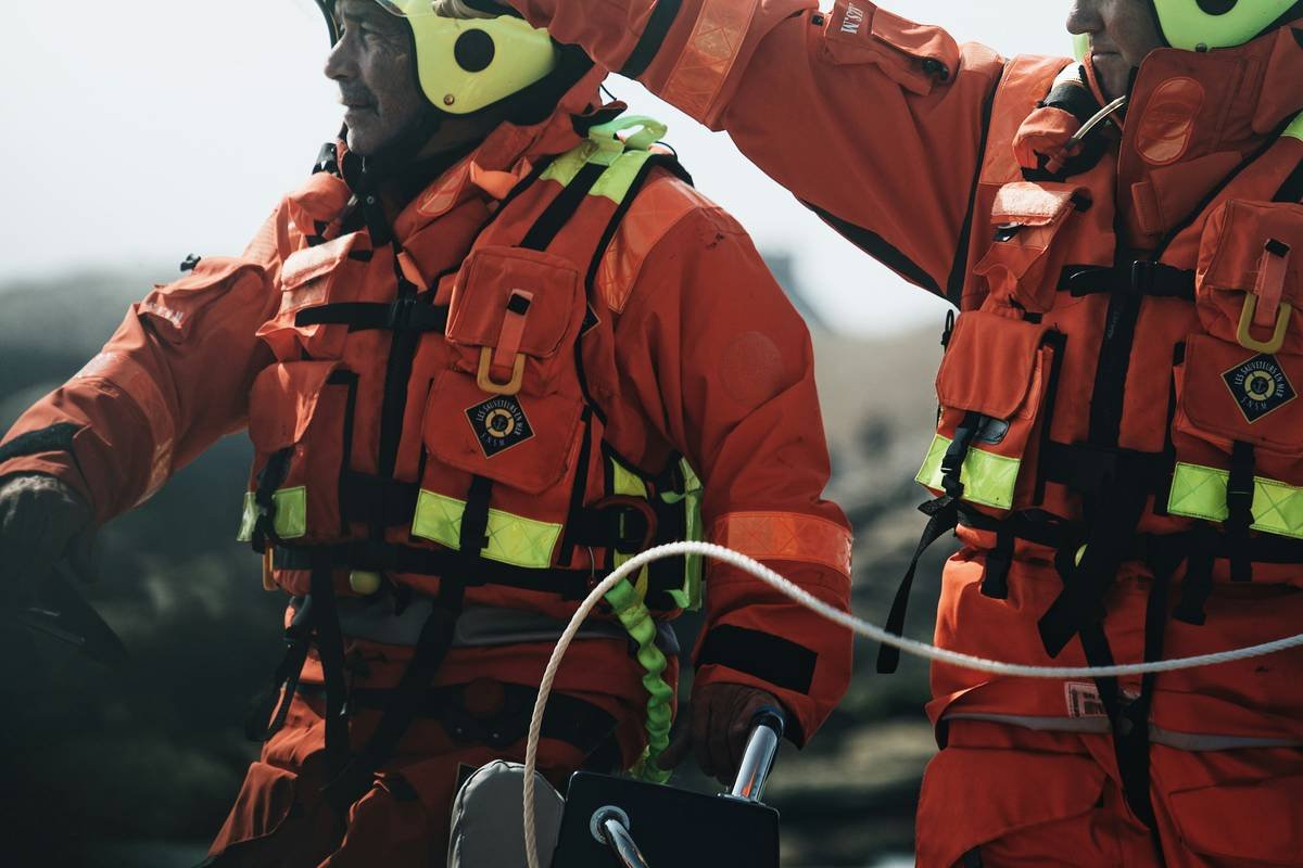 a couple of men in life jackets standing next to each other