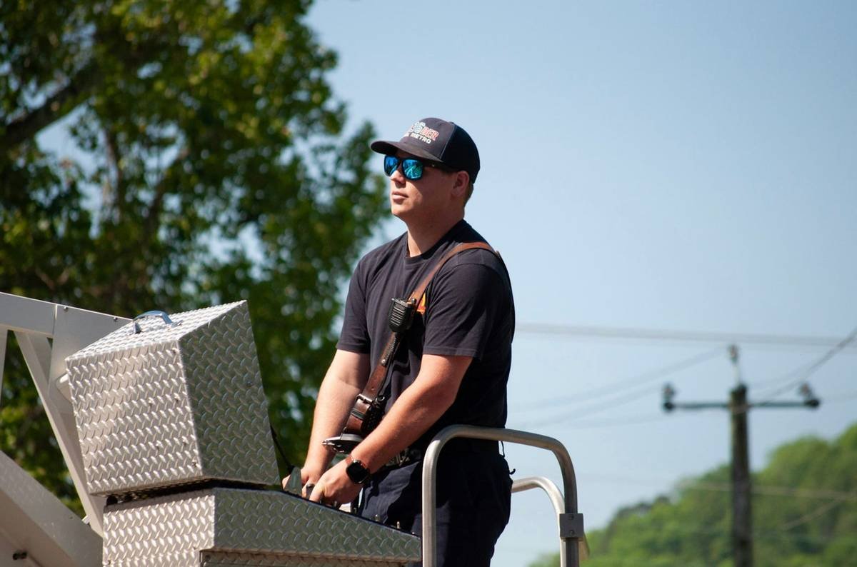 Man in sunglasses on a ladder truck