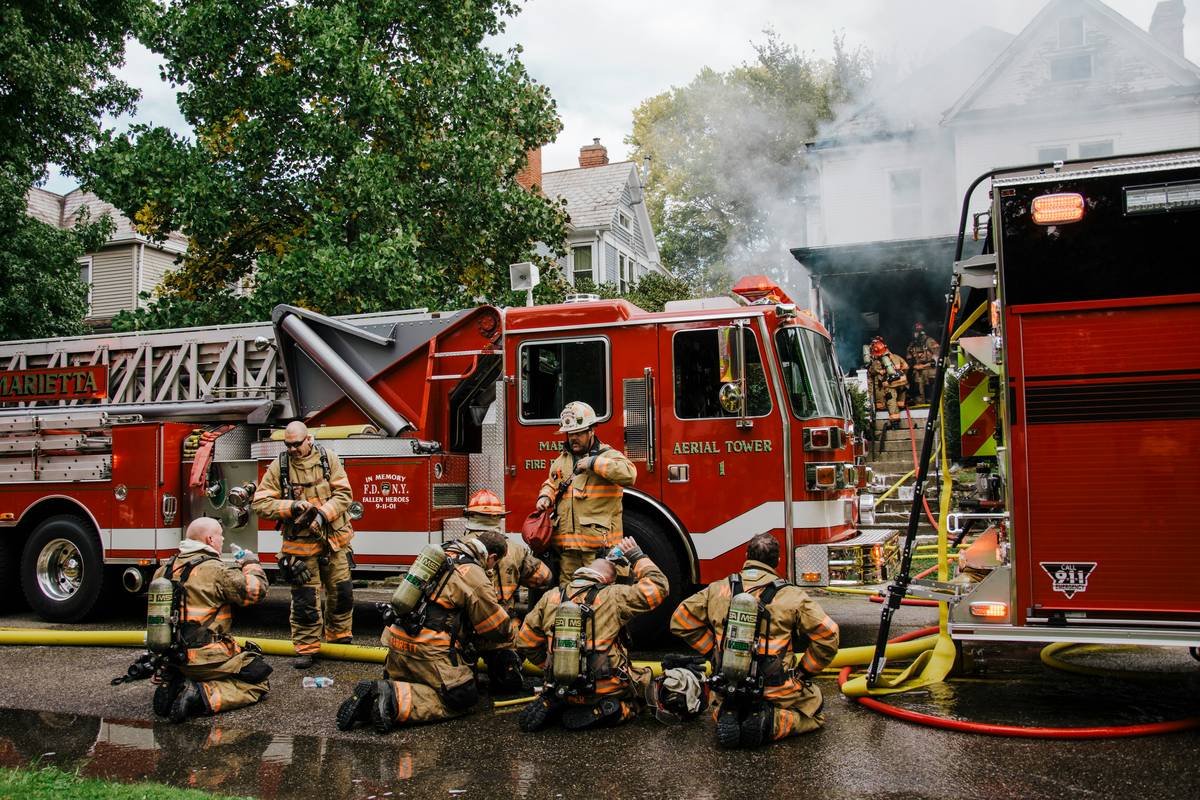 First responder reviewing policy documents highlighting hero coverage travel exclusions