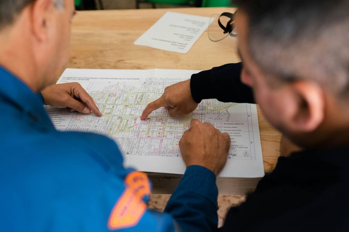 First responder using satellite phone to coordinate evacuation under risk shield travel basics policy